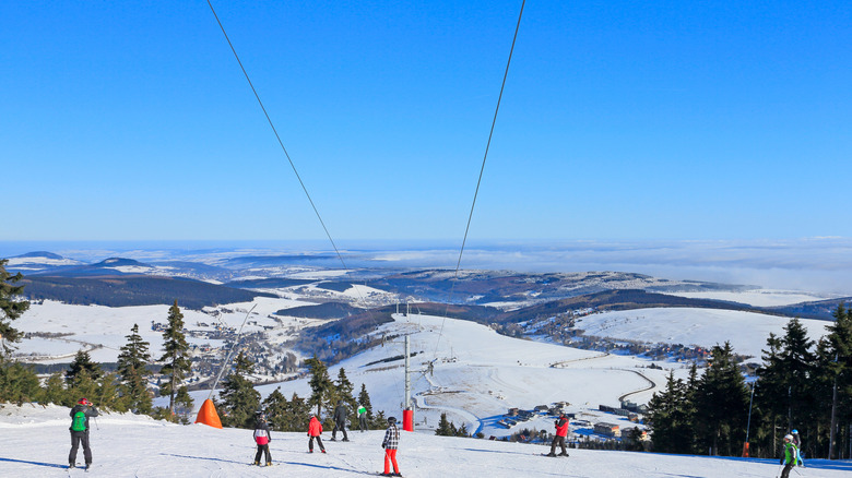 Klinovec skiers on the mountain with a ski lift