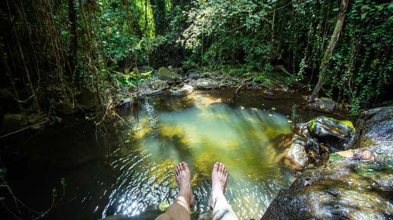 feet dangling swimming hole Hawaii