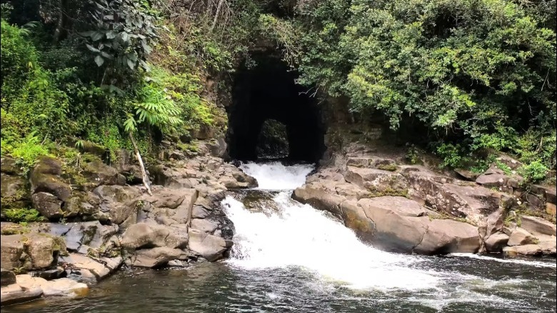 Water flowing through a manmade cave and down into a pool in Hawaii
