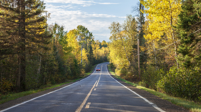 Curve in the Gunflint Trail in Superior National Forest, northern Minnesota, at sunset during autumn