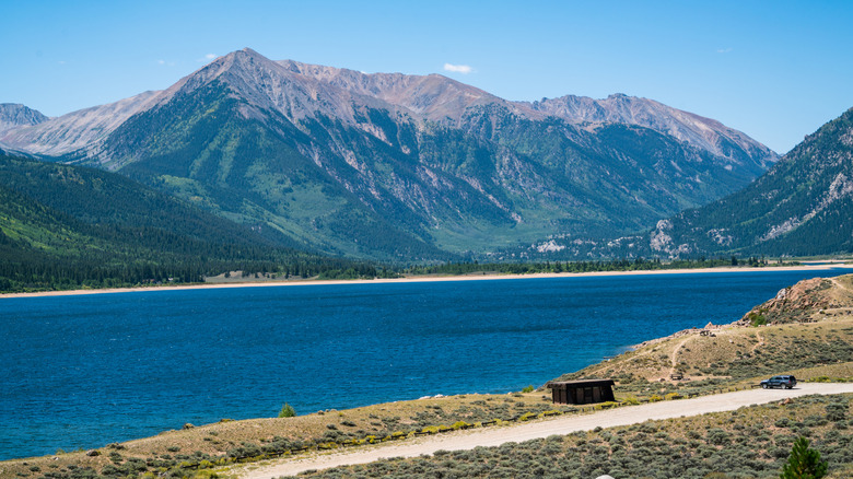 a small parking space with a single car besides Twin Lakes and Mount Elbert, Colorado in the summertime