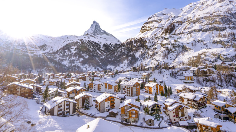 Sun shining on snow covered Swiss valley with the Matterhorn in the background