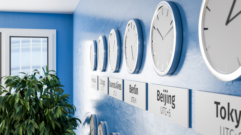 Different clocks with different timezones and cities (Honolulu, Chicago, Buenos Aires, Berlin, Beijing, and Tokyo) on a wall