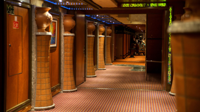 Cruise ship interior with column fixtures inspired by ancient Greece, dim lighting, and neon on the Carnival Glory ship