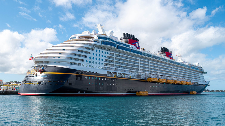 Disney Dream cruise ship in port in Nassau, Bahamas on a sunny day with clear, turquoise water