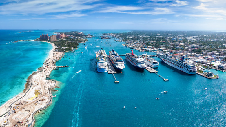Panoramic aerial view of the port of Nassau with numerous cruise ships lined up and beautiful Paradise Island visible