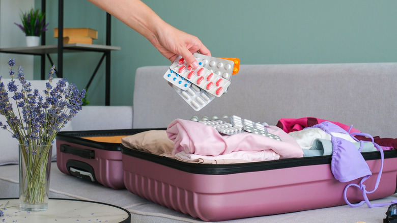 Person packing medication in bag
