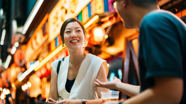 Two people speaking in street