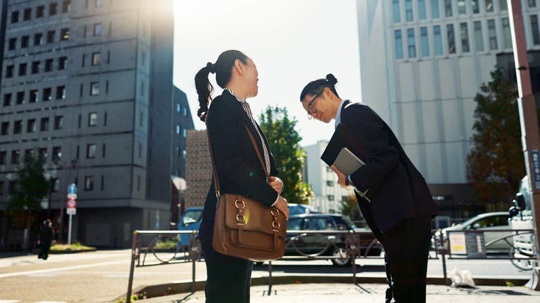 Man bowing to woman