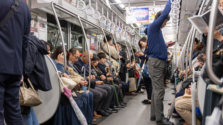 People ride on subway train