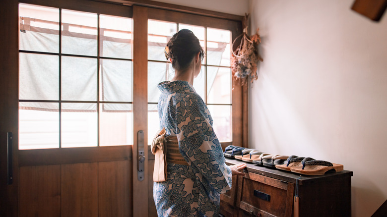 Woman in kimono with shoe rack