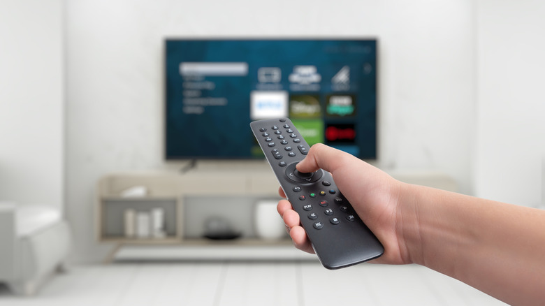 Person using smart TV remote