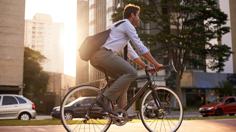 A man biking through city street