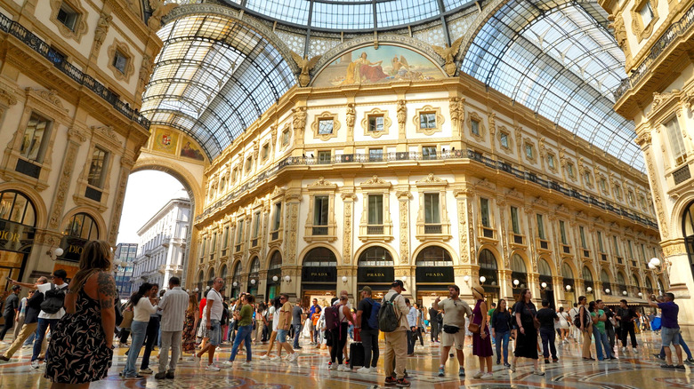 The glass-domed gallery of the Piazza del Duomo in Milan packed with people