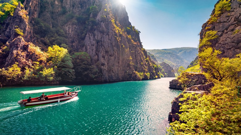Majestic spring view of Matka Canyon in North Macedonia with small cruise boat