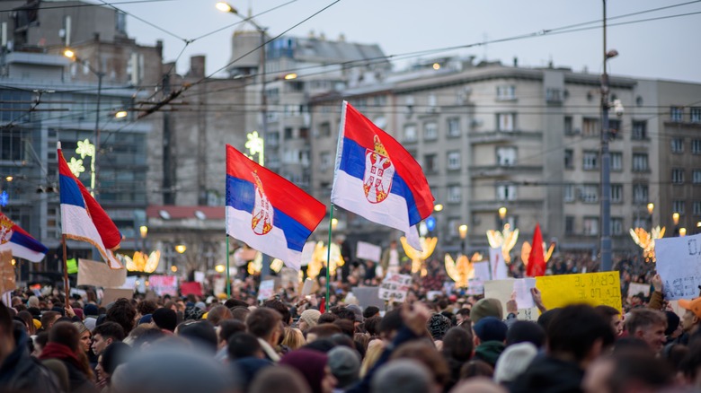 Serbian students and citizens protest in a city plaza against government corruption