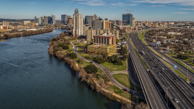 Aerial photo taken over Interstate Highway 35 featuring Lady Bird Lake and the Austin, Texas skyline