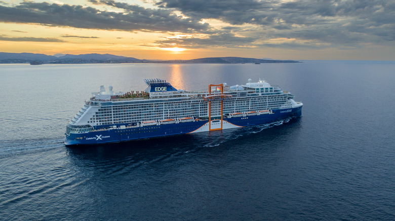 Celebrity Edge cruise ship sailing in open water at sunset