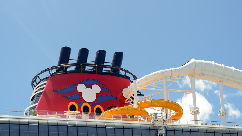 Funnel of Disney Triton Class cruise ship featuring the Disney Cruise Line logo and waterslide