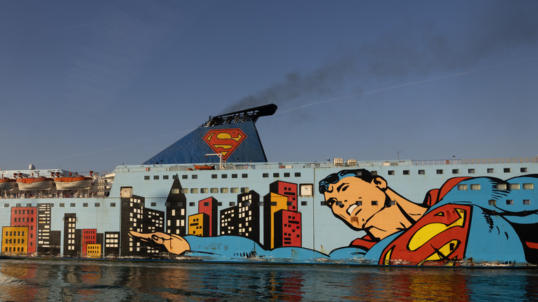 Super Tirrenia, a superhero themed curise ship painted with a Superman mural, sits in port