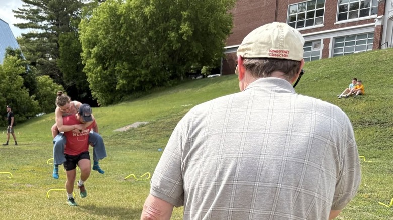 Man carrying woman on his back in the Wife-Carrying Competition in Hancock, Michigan