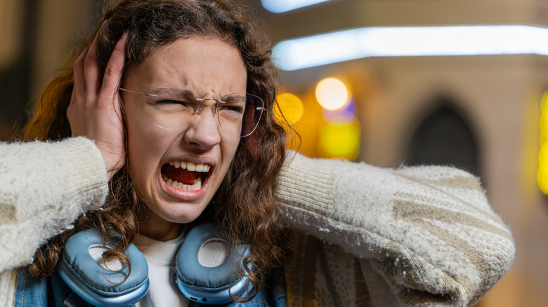 Woman suffering from loud noise