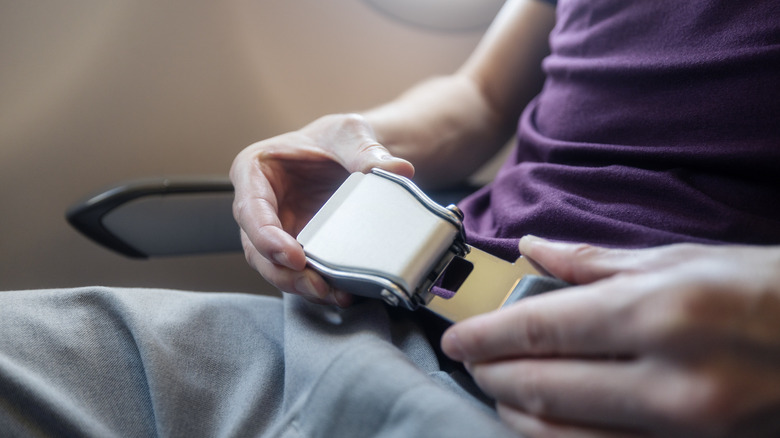 Fastening airplane seat belt