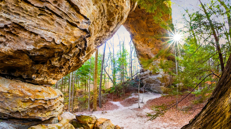 The sun shines behind the Twin Arches formation in Tennessee.