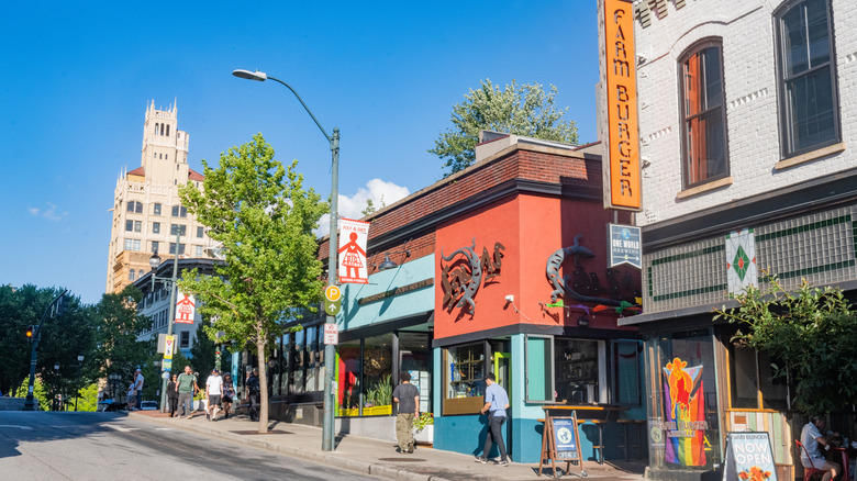 Eclectic storefronts in downtown Asheville featuring Pride flags
