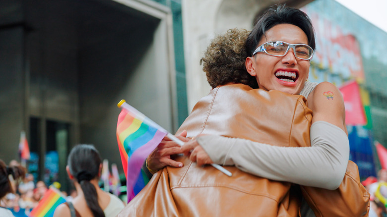 An LGBT couple embracing at a Pride event