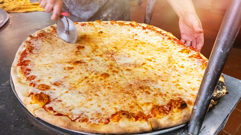 New York pizza being cut
