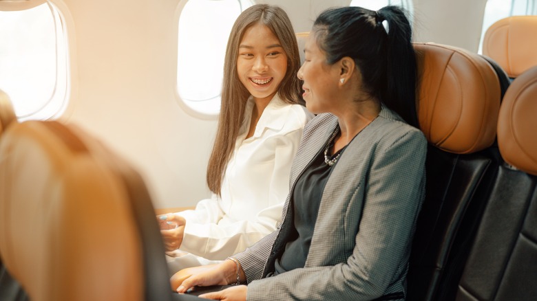 Two women chatting on plane