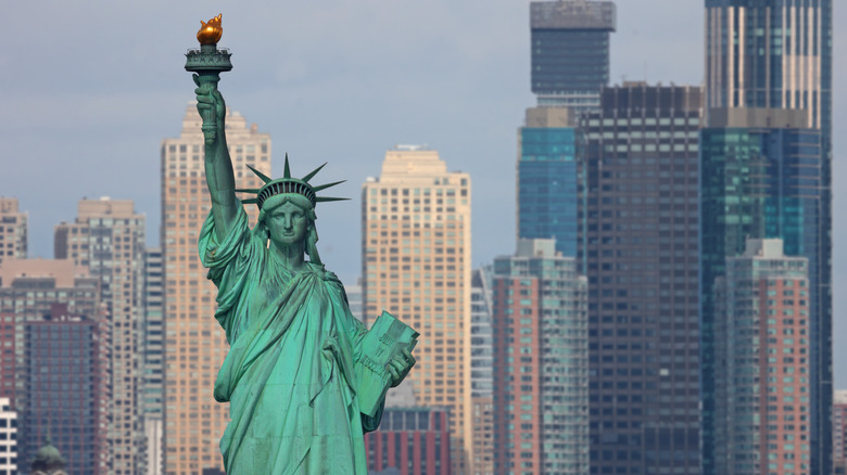 The Statue of Liberty against the NYC skyline.