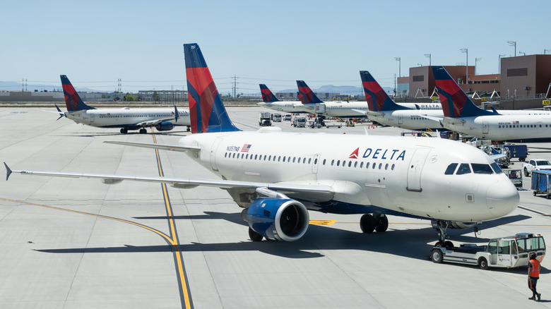 Airplanes with Delta logo parked at airport terminal
