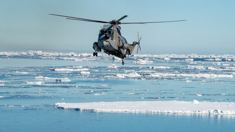 A helicopter flying over the Antarctic