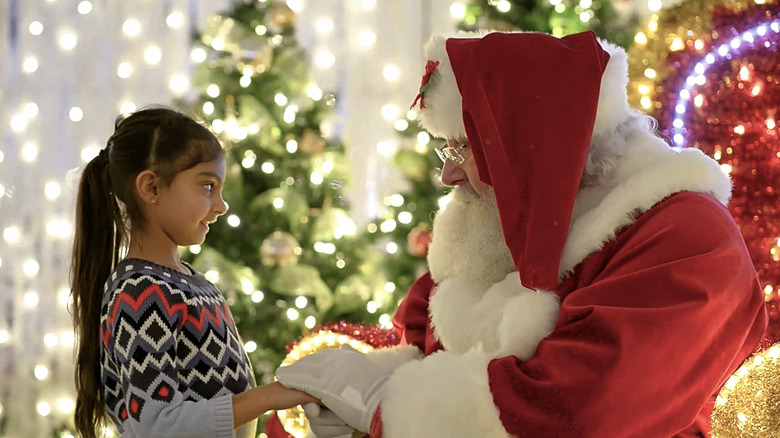 A young girl meets Santa at Glow Hartford.