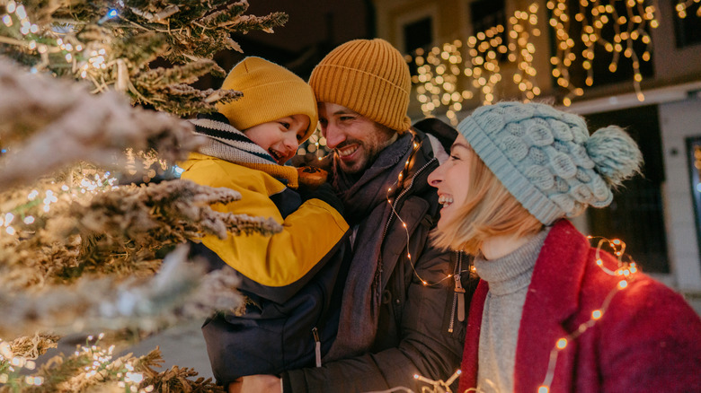 Photo of a young family celebrating Christmas outdoors.