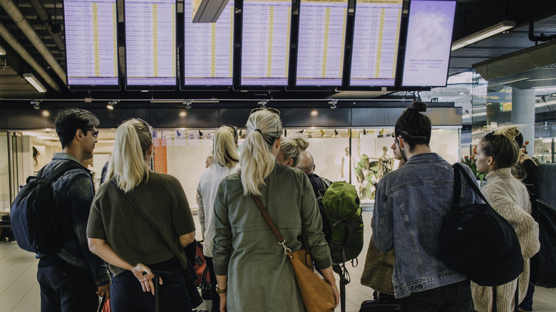Travelers looking at flight times