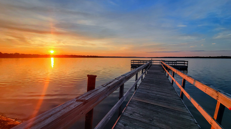 Sunrise with vibrant colors over a lake and fishing dock, Detroit Lakes, Minnesota