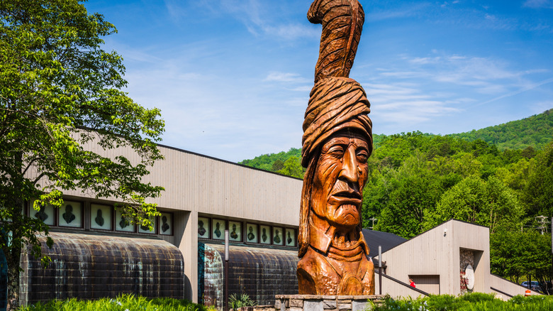 A large wooden sculpture outside of the Museum of the Cherokee People