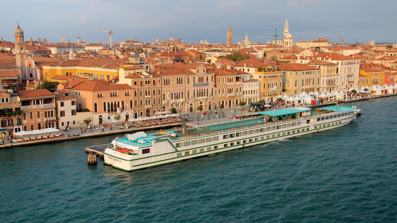 CroisiEurope boat Michelangelo on the Po River and the Venetian Lagoon, with Venice in the background.