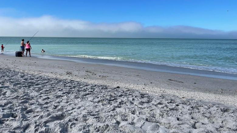 Couple fishing off the beach