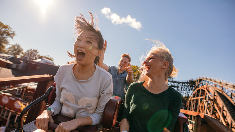 Two women screaming on a roller coaster.