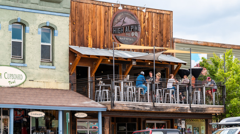 People eating on the balcony of a bar in downtown Gunnison, Colorado