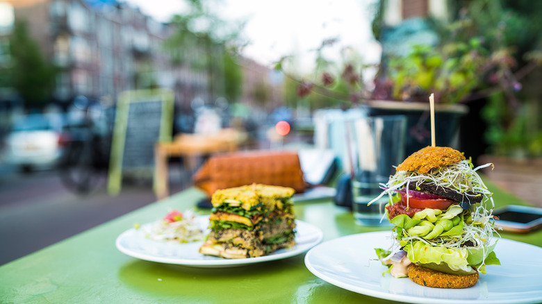 Raw vegan food on on a table of sidewalk cafe on Amsterdam street