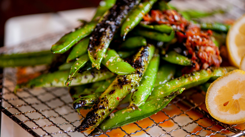 Edamame beans on a grill in Tokyo, seasoned with garlic, lemons and coarse sea salt.