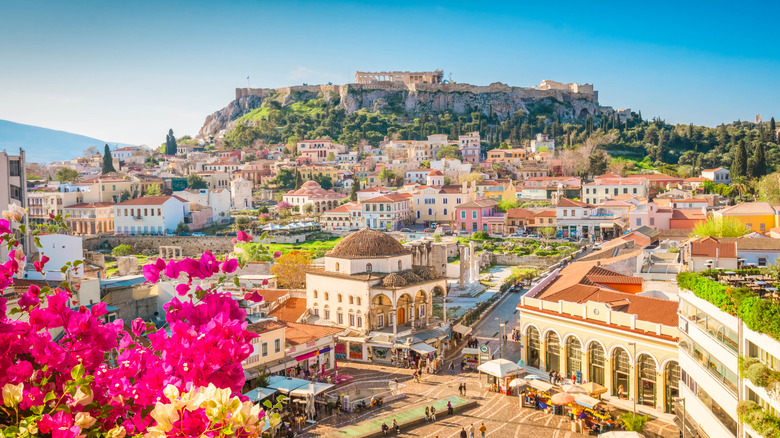 Athenian skyline featuring the Acropolis and archway-heavy buildings in the foreground