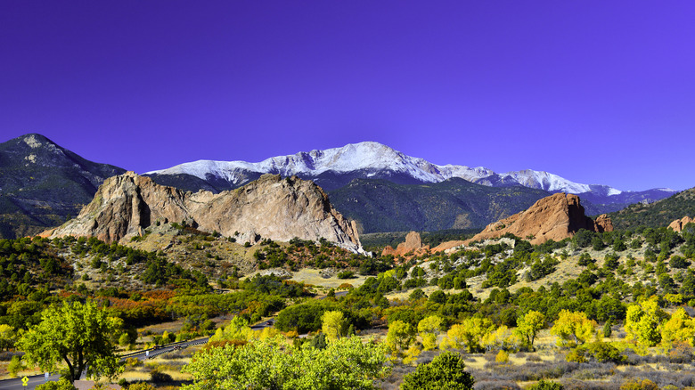 Snowcapped Pikes Peak in Colorado with the red-rock formations of Garden of the Gods