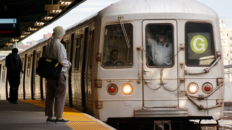 A commuter waits for the G Line train in New York