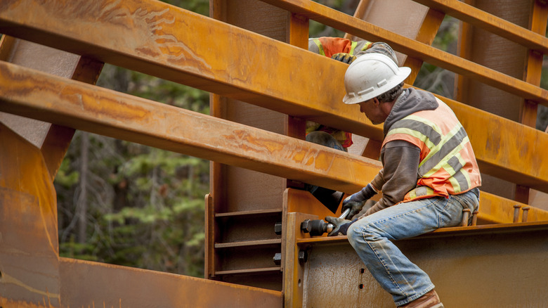 Steel workers on a bridge across Rubicon Creek, El Dorado National Forest, California.